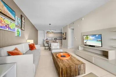 a living room with a couch and a tv at Breathtaking Ocean-View Balcony Lyfe Resort in Hollywood Beach