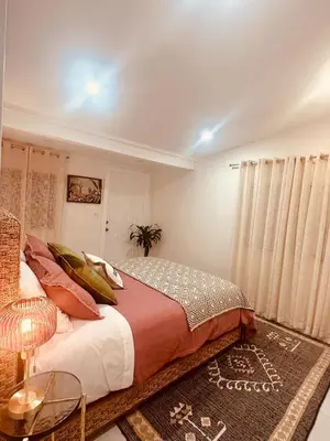 a bedroom with a bed and a table and curtains at Charming Home Close to Beaches & Downtown in Miami
