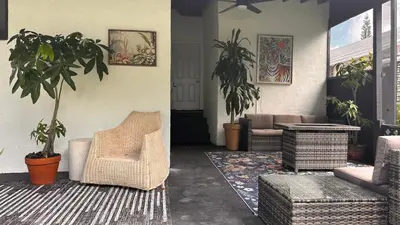 a living room with a chair and a plant at Charming Home Close to Beaches & Downtown in Miami