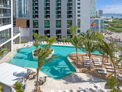 an overhead view of a swimming pool with palm trees and buildings at Magic Miami Penthouse, Ocean & City Views, Pool, Spa, Gym, in Miami