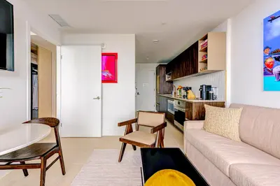 a living room with a couch and a table at Magic Miami Penthouse, Ocean & City Views, Pool, Spa, Gym, in Miami