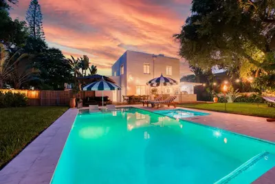a swimming pool in the backyard of a house at Stunning Historic Villa with Jacuzzi Heated Pool and Resort style Backyard in Miami
