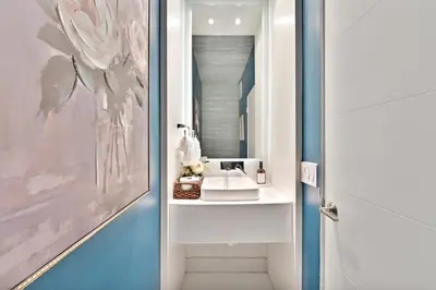 a bathroom with a sink and a mirror at Stunning Historic Villa with Jacuzzi Heated Pool and Resort style Backyard in Miami