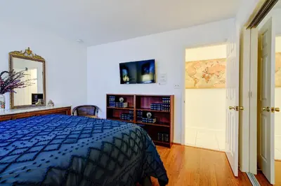a bedroom with a bed and a dresser and a mirror at Classic Modern 3-Bedroom Oasis in Fort Lauderdale