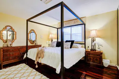 a bedroom with a canopy bed and two mirrors at Classic Modern 3-Bedroom Oasis in Fort Lauderdale