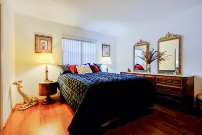 a bedroom with a bed and a dresser and mirror at Classic Modern 3-Bedroom Oasis in Fort Lauderdale