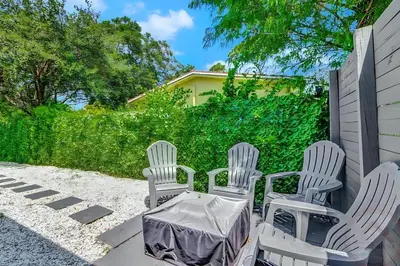 three white chairs and a table on a patio at Fort Lauderdale Home near Nightlife and Beach in Fort Lauderdale