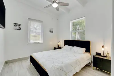 a white bedroom with a bed and a ceiling fan at Fort Lauderdale Home near Nightlife and Beach in Fort Lauderdale