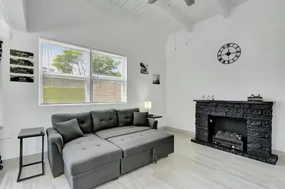 a living room with a couch and a fireplace at Fort Lauderdale Home near Nightlife and Beach in Fort Lauderdale
