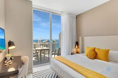 a bedroom with a bed and a view of the ocean at Penthouse with Free Parking and Beautiful Amenities in Hollywood