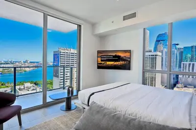 a bedroom with a bed and large windows at Gorgeous Unit in the Heart of Downtown Miami in Miami