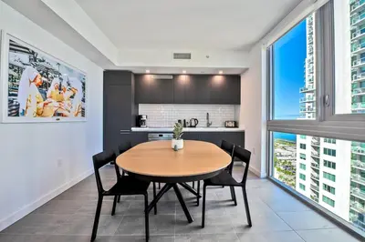 a kitchen and dining room with a table and chairs at Gorgeous Unit in the Heart of Downtown Miami in Miami