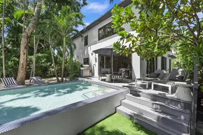 a swimming pool in the backyard of a house at The Waterhouse- Amazing Villa With Infinity Pool in Miami