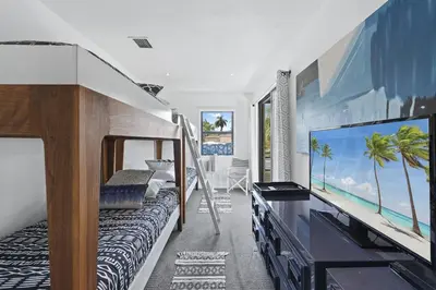 a bedroom with a bed and a large screen tv at The Waterhouse- Amazing Villa With Infinity Pool in Miami