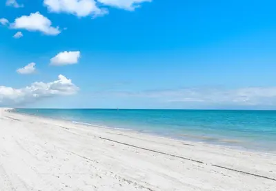 a sandy beach with the ocean in the background at Beachwalk Family Studio- Beach Pool Gym & Bay View in Hallandale Beach