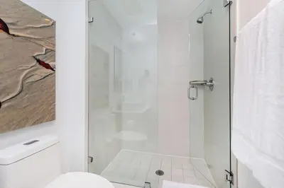 a shower with a glass door in a bathroom at Beachwalk Family Studio- Beach Pool Gym & Bay View in Hallandale Beach