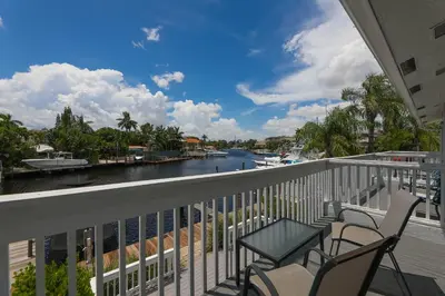 a balcony with chairs and a view of a river at Cozy Retreat in Fort Lauderdale