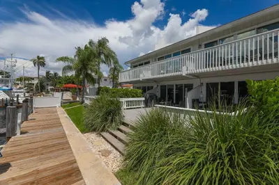 a house with a wooden walkway in front of it at Cozy Retreat in Fort Lauderdale