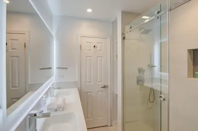 a white bathroom with a sink and a shower at Cozy Retreat in Fort Lauderdale