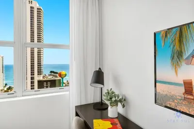 a living room with a television and a table with a lamp at Beautiful apartment with Amazing Pool Balcony in Hollywood