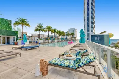 a balcony with a swimming pool and palm trees at Beautiful apartment with Amazing Pool Balcony in Hollywood