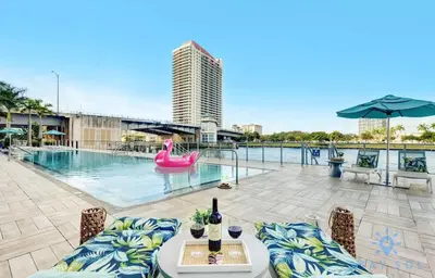 a swimming pool with a pink inflatable raft at Beautiful apartment with Amazing Pool Balcony in Hollywood