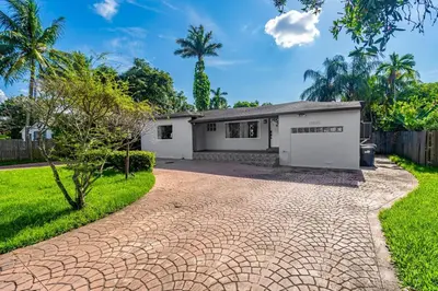 a house with a driveway in front of it at Spacious 3 bedroom Home with Oversized Pool & Backyard in Miami