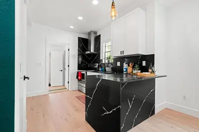 a kitchen with a black and white counter top at Farfalla XX in Miami