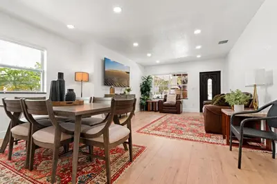 a dining room and living room with a table and chairs at Farfalla XX in Miami
