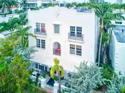 an aerial view of a white building with palm trees at S BEACH SPOT Heated pool 2BLOCKs to BEACH BBQ in Miami Beach