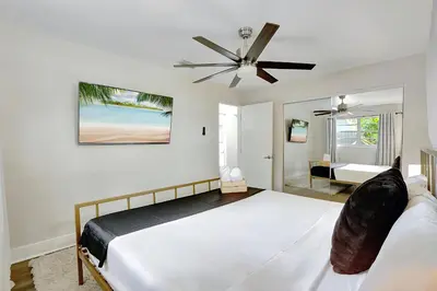a bedroom with a bed and a ceiling fan at Fort Lauderdale Tropical Oasis Pool Retreat in Fort Lauderdale