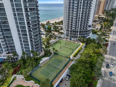 an aerial view of a tennis court between two tall buildings at Lujoso apartamento en playa de Sunny Isles Beach in Sunny Isles Beach