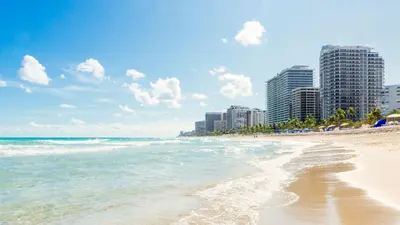 a beach with buildings in the background and the ocean at Villa Jazmin Beach in Miami Beach
