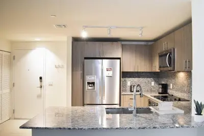 a kitchen with a stainless steel refrigerator and a counter at Luxury apartment in Doral miami, 1 Bd in Miami