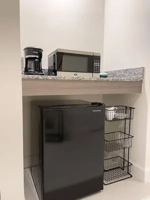a kitchen with a counter with a microwave and a refrigerator at Comfortable Studio suites in downtown Doral in Miami