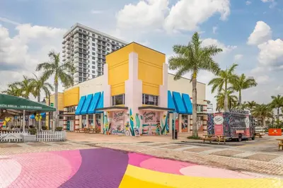 a building with a colorful mural on the side of it at Comfortable Studio suites in downtown Doral in Miami