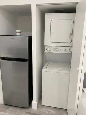 a kitchen with a refrigerator and a washer and dryer at Newly renovated studio close to the beach in Hollywood