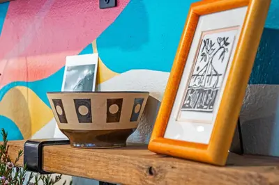 a wooden table with a picture frame and a bowl at The SurfSide Hideout Charming Cozy Central in Miami