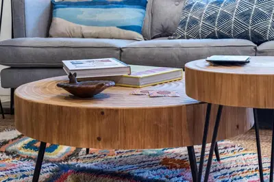 a living room with a coffee table with books and a couch at The SurfSide Hideout Charming Cozy Central in Miami