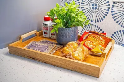 a wooden tray with bread and food on a table at The SurfSide Hideout Charming Cozy Central in Miami
