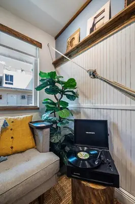 a room with a laptop computer on a table next to a plant at The SurfSide Hideout Charming Cozy Central in Miami