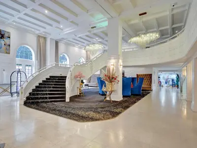 a lobby with a staircase and blue chairs at High Floor Adorable 2 Bedroom Condo Resort 1606 in Miami Beach