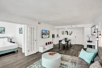 a living room with a bed and a table at Adorable 2 Bedroom Condo Beach Service 1110 in Miami Beach
