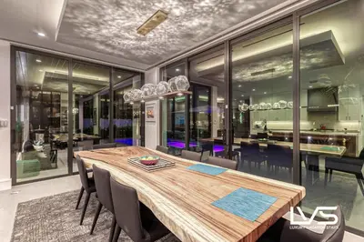 a dining room with a wooden table and chairs at Carlotta- New Construction Luxury Waterfront Villa in Fort Lauderdale