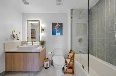 a bathroom with a toilet and a sink and a shower at Upscale 1-BD Condo with Stunning City Views in Miami