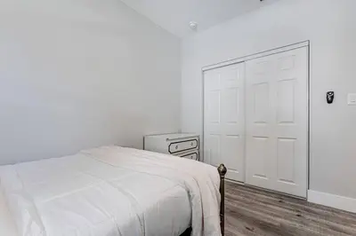 a white bedroom with a white bed and a door at Miami Modern Oasis Retreat - Close to Airport in Miami