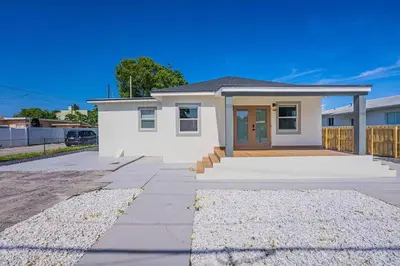 a small white house with a driveway at Miami Modern Oasis Retreat - Close to Airport in Miami