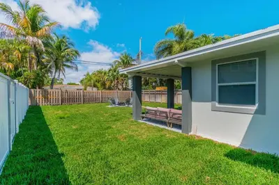 a house with a bench in a yard at Cozy Victoria Park Retreat Unit 3 - Las Olas Beach in Fort Lauderdale