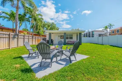 a patio with chairs and a table in a yard at Cozy Victoria Park Retreat Unit 3 - Las Olas Beach in Fort Lauderdale