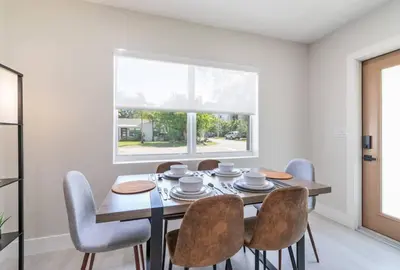 a dining room with a table and chairs and a window at Cozy Victoria Park Retreat Unit 3 - Las Olas Beach in Fort Lauderdale